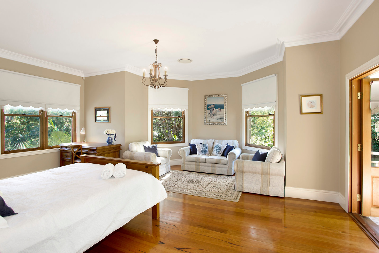 Light-filled sitting room with bay windows and garden views
