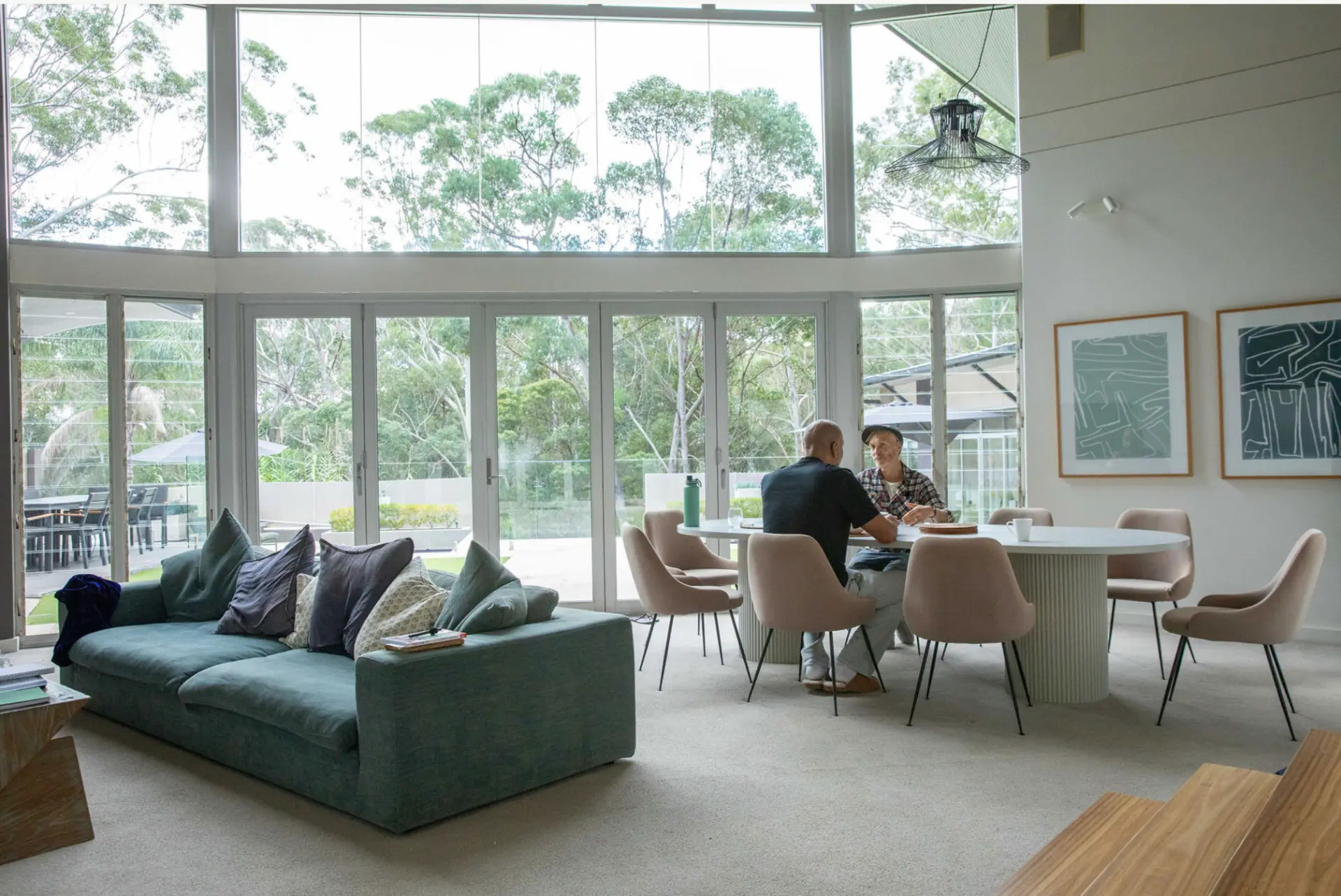 Bright open-plan living and dining space with floor-to-ceiling garden views