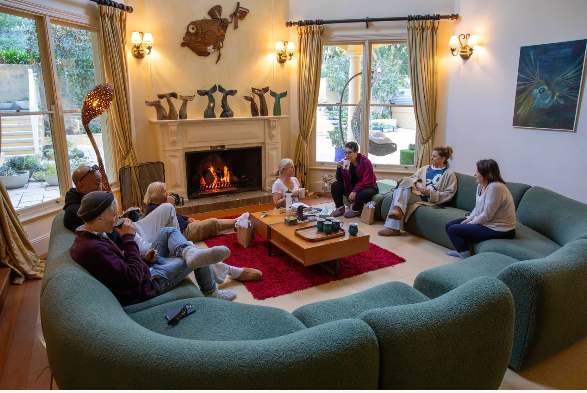 Participants gathered by the fireplace in a relaxed lounge